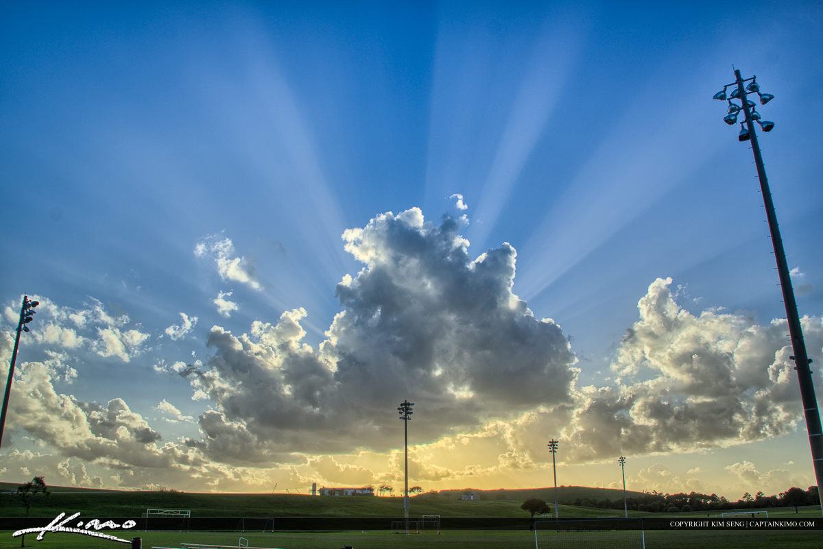 Soccer Field Outdoor Sports with Sunrays Clouds in Sky